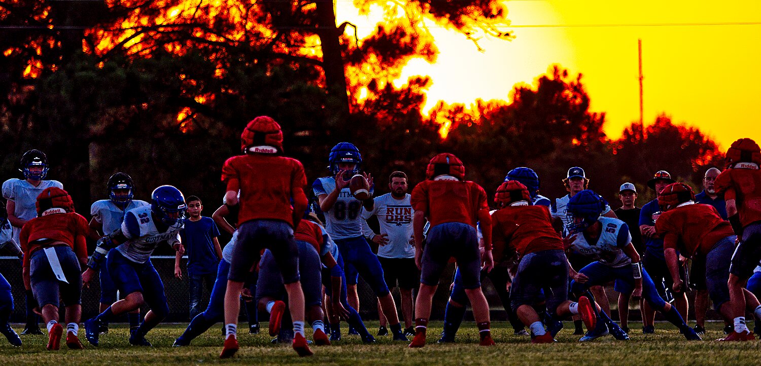 The Panther defense faces the Bulldog offense and the setting sun. [preview further Panther pics or buy Bulldog action]